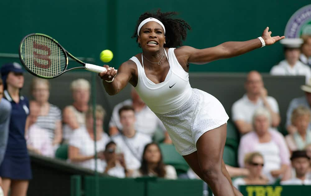 Serena Williams of the United States returns a shot to Timea Babos of Hungary during their singles match at the All England Lawn Tennis Championships in Wimbledon, London.