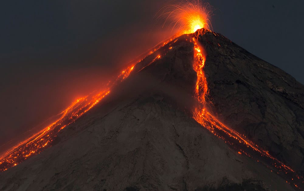 In this image taken with a long exposure, the Volcan de Fuego, or Volcano of Fire, spews hot molten lava from its crater in San Juan Alotenango, Guatemala. The Guatemalan emergency agency CONRED raised the alert level in the area after the volcano restarted its activity on early Wednesday.