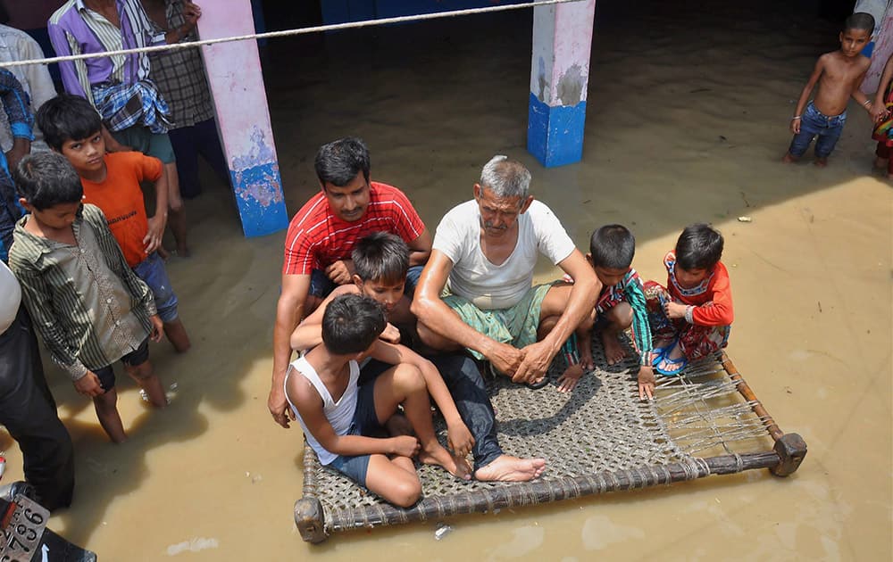 People in a flooded locality in Moradabad district following heavy rain storms.