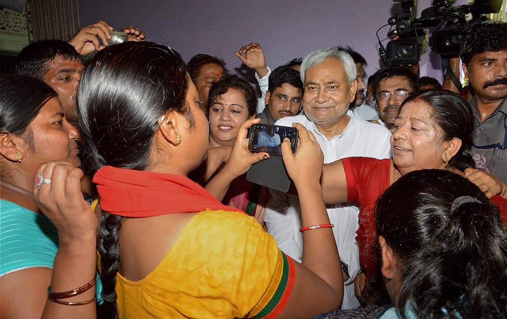 Women click pictures with Bihar chief minister Nitish Kumar Har Ghar Dastak, his door to door campaign for the state elections, in Patna.