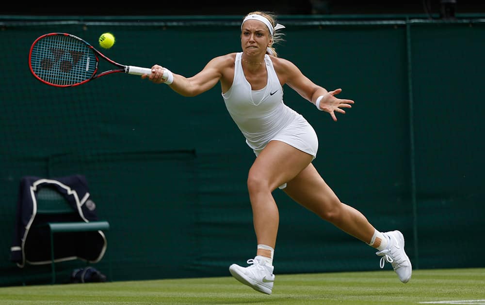 Sabine Lisicki of Germany returns a ball to Christina Mchale of the United States, during their singles match at the All England Lawn Tennis Championships in Wimbledon, London.