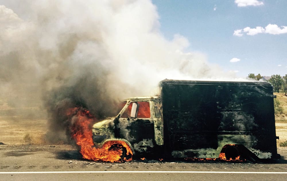 Smoke rises from a burning truck packed with fireworks after it exploded on Interstate 15 near Ivanpah, Calif., close to the Nevada state line.