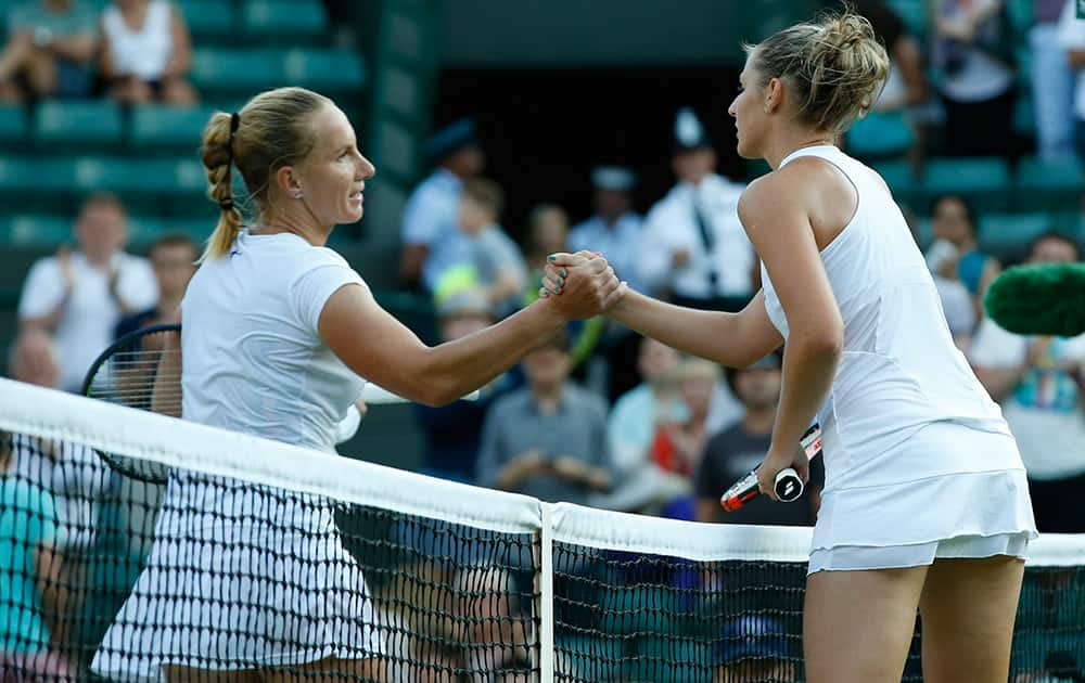 Kristyna Pliskova of the Czech Republic shakes hands at the net with Svetlana Kuznetsova of Russia after their singles match at the All England Lawn Tennis Championships in Wimbledon, London. Pliskova won 3-=6, 6-3, 4-6. 