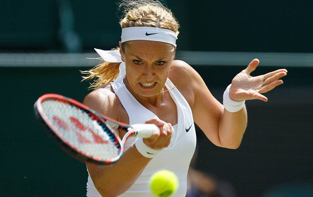 Sabine Lisicki of Germany makes a return to Christina McHale of the United States during their singles match at the All England Lawn Tennis Championships in Wimbledon, London.