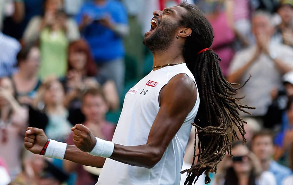 Dustin Brown of Germany celebrates after defeating Rafael Nadal of Spain, during their singles match, at the All England Lawn Tennis Championships in Wimbledon, London.