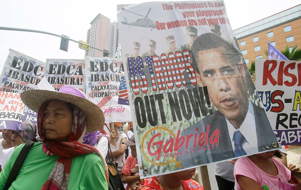 Protesters from the women's group Gabriela display placards during a rally near the US Embassy in Manila, ahead of Fourth of July celebrations in the US. as US-Philippines Friendship Day. The protesters denounced the lopsided friendship between the US and the Philippines which according to them benefits only the US.