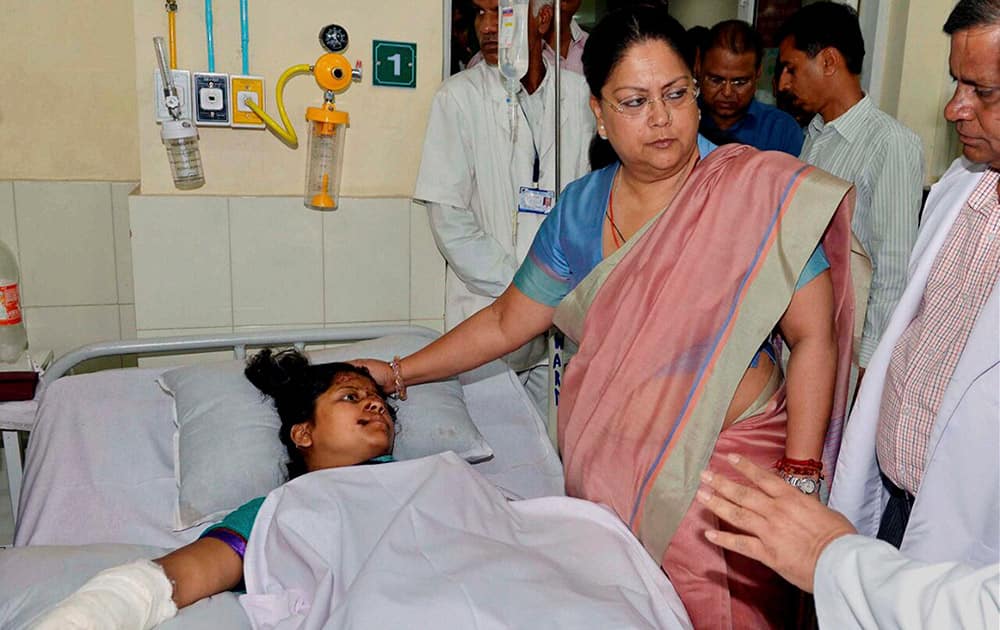 Rajasthan Chief Minister Vasundhara Raje meets with an injured woman undertreatment at a hospital following an accident with Actress & BJP MP Hema Malini's car.