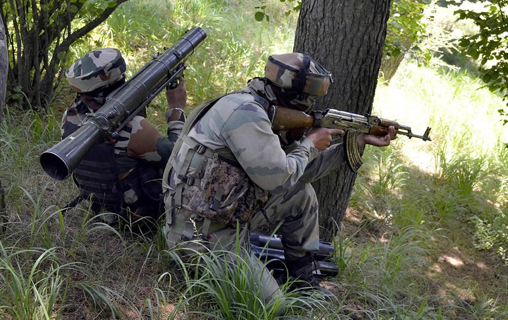 Army personnel take positions during an encounter with militants near the Line of Control in Uri sector of north Kashmir.