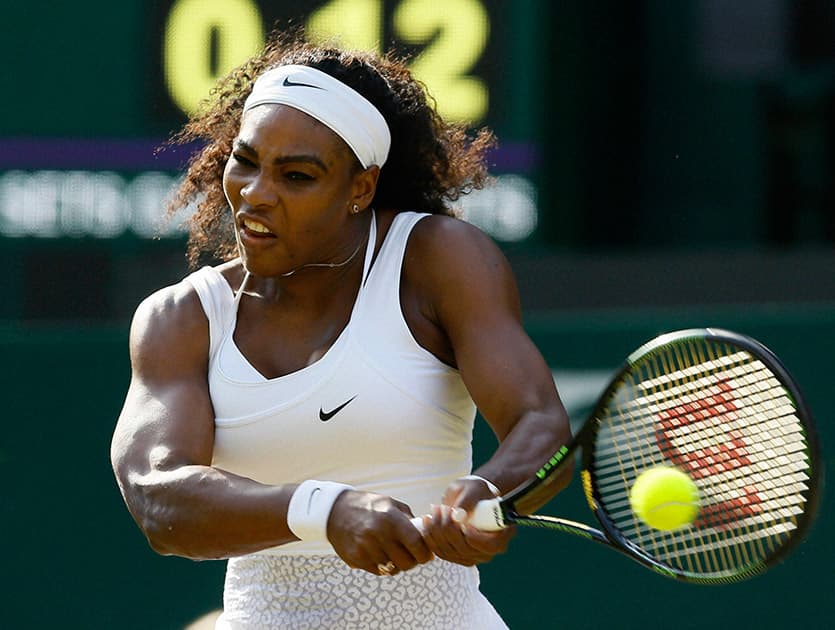 Serena Williams of the United States returns a ball to Heather Watson of Britain during their singles match at the All England Lawn Tennis Championships in Wimbledon.