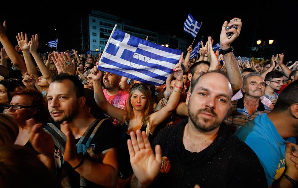 Demonstrators react during a speech by Greece's Prime Minister Alexis Tsipras at a rally organized by supporters of the No vote in Athens.