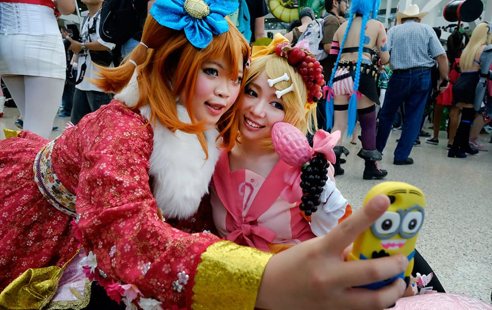 Fans in costumes take a selfie at the 24th annual Anime Expo held at the Los Angeles Convention Center.