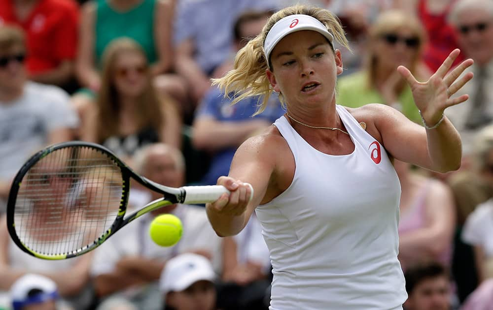 Coco Vandeweghe of the United States returns a ball to Samantha Stosur of Australia during their singles match at the All England Lawn Tennis Championships in Wimbledon.