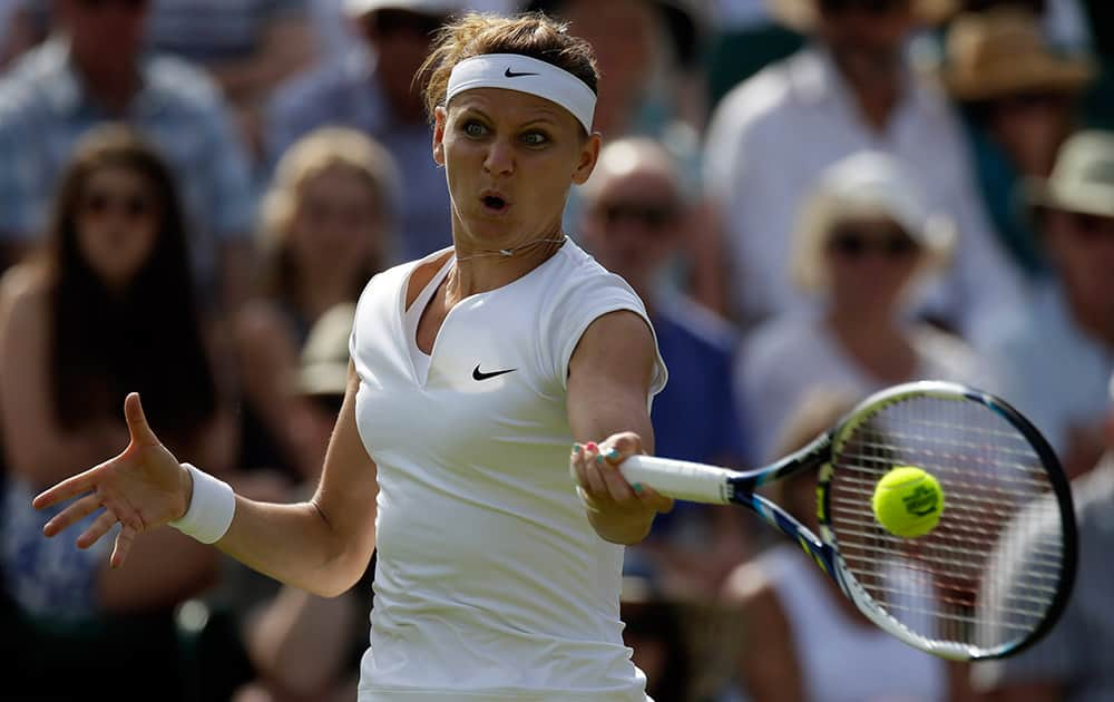 Lucie Safarova of the Czech Republic makes a return to Sloane Stephens of the United States during their singles match at the All England Lawn Tennis Championships in Wimbledon.