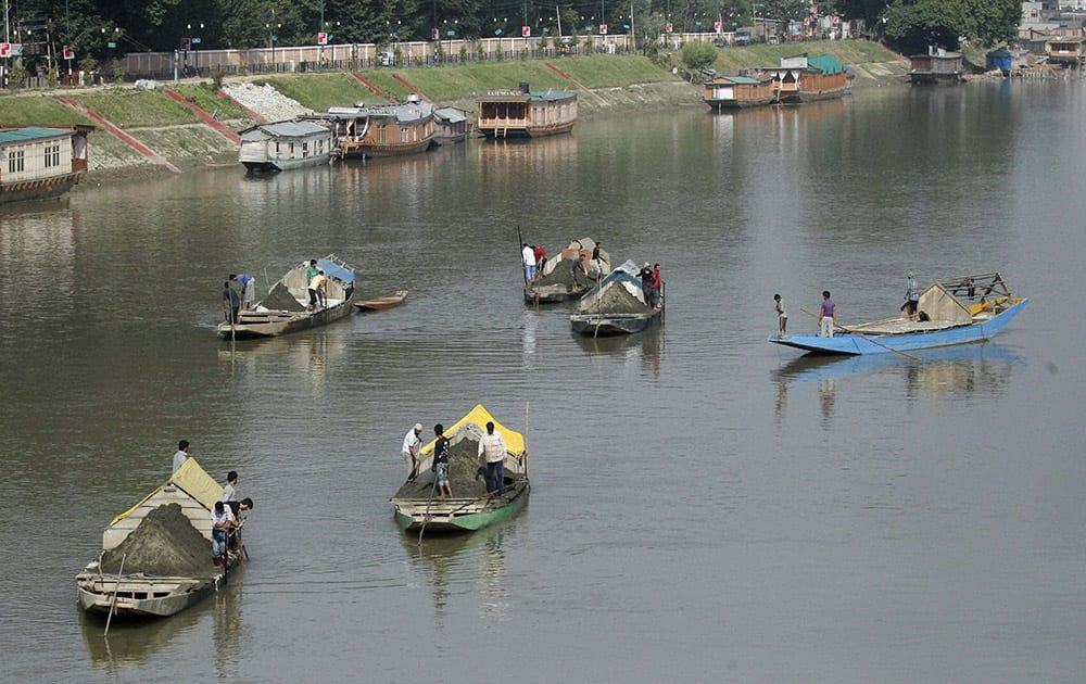 Labourers extract sand from the Jhelum River in Srinagar.