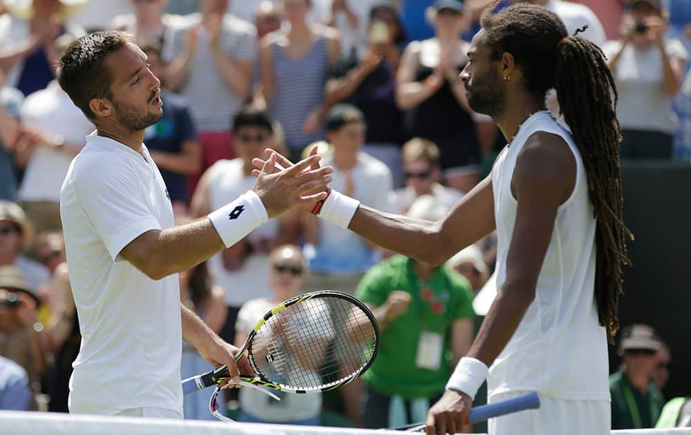 Viktor Troicki of Serbia shakes hands after defeating Dustin Brown of Germany in their singles tennis match at the All England Lawn Tennis Championships in Wimbledon, London. Troicki won the match 6-4, 7-6, 4-6, 6-3. 