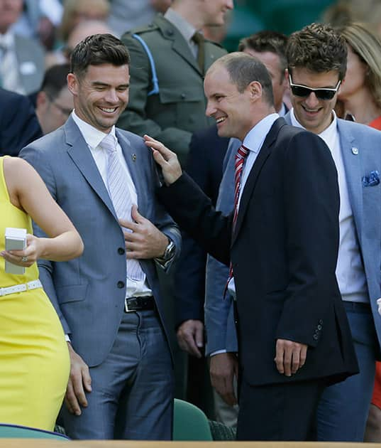 England cricketer James Anderson and Andrew Strauss take their seats in the Royal Box on Centre Court at the All England Lawn Tennis Championships in Wimbledon, London.