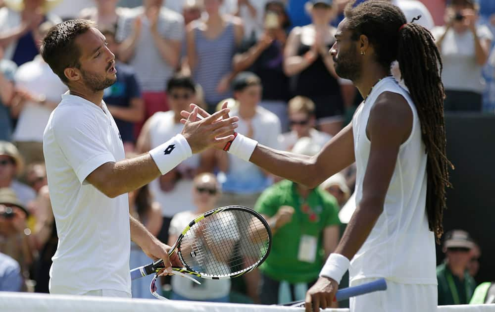 Viktor Troicki of Serbia shakes hands after defeating Dustin Brown of Germany in their singles tennis match at the All England Lawn Tennis Championships in Wimbledon, London. Troicki won the match 6-4, 7-6, 4-6, 6-3. 