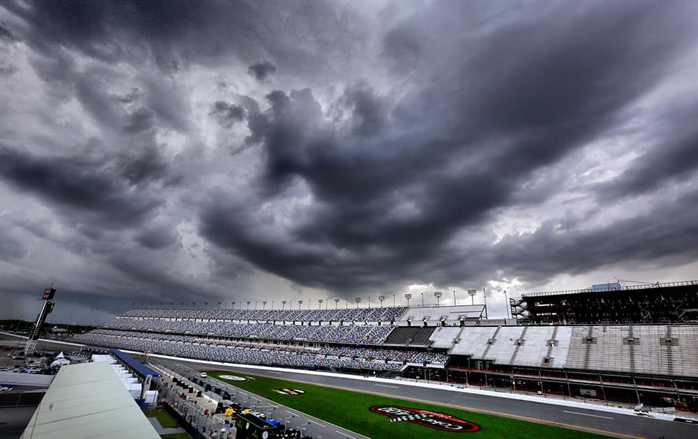 Storms clouds tower over Daytona International Speedway as qualifying for the NASCÅR Sprint Cup auto race was canceled in Daytona Beach, Fla.