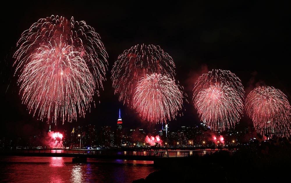 Fireworks explode over the East River in front of the Manhattan skyline as seen from the Brooklyn borough of New York during the Macy's Fourth of July fireworks show.