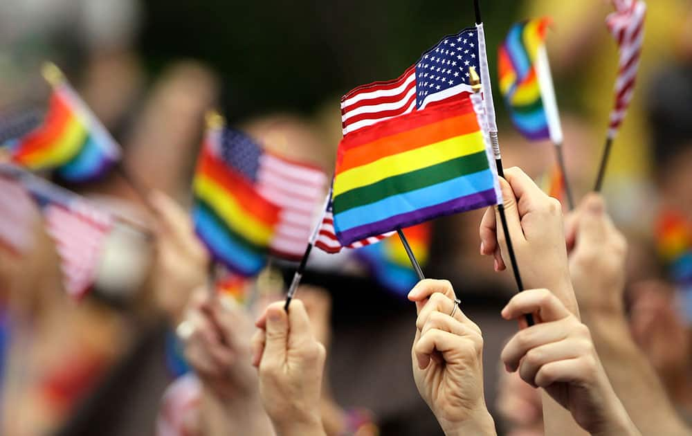 Flags are waved during the National LGBT 50th Anniversary Ceremony, in front of Independence Hall in Philadelphia. 