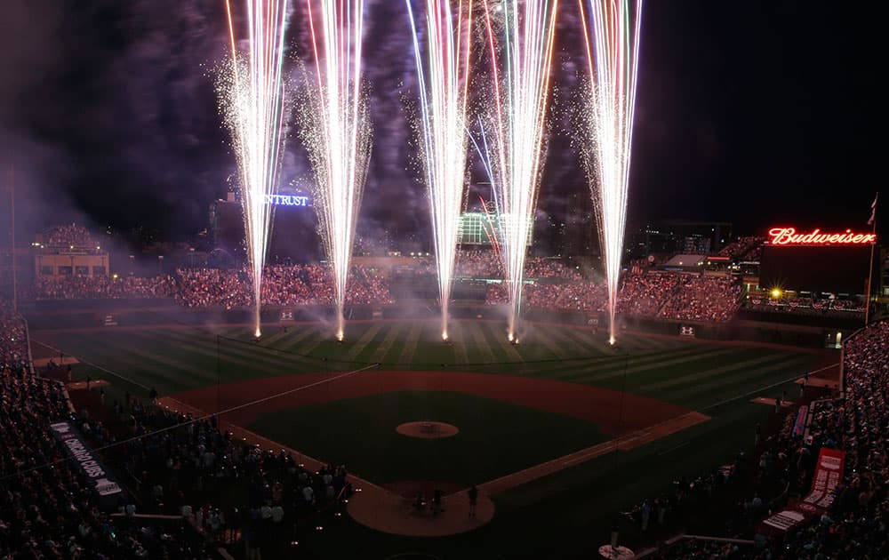 Fans watch a Fourth of July fireworks display after the Chicago Cubs defeated the Miami Marlins 7-2 in a baseball game, in Chicago.