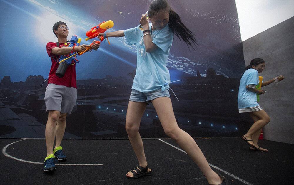 people fire their water guns in a battle maze in Beijing.
