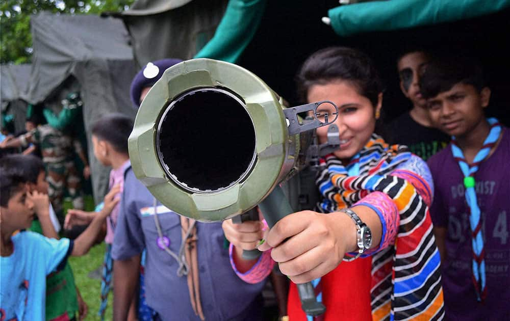 A student having look of a rocket launcher at an exhibition organised by the Indian Army.