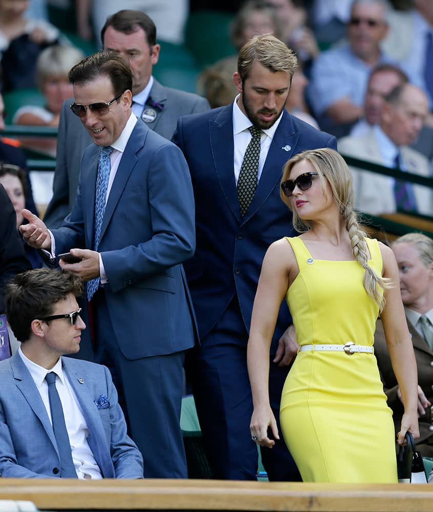 Professional dancer Anton du Beke, second left, England rugby captain Chris Robshaw, centre right, and his girlfriend Camilla Kerslake-Morgan take their seats in the royal box on Centre Court at the All England Lawn Tennis Championships in Wimbledon, London.