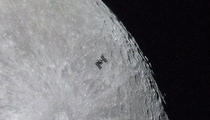 Photographer captures International Space Station flying across moon