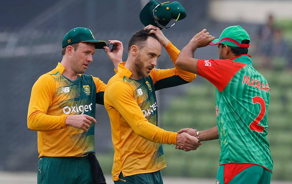 South Africa’s captain Faf du Plessis, center, shakes hand with Bangladesh’s captain Mashrafe Mortaza, right, as AB de Villiers, left, joins after their win over Bangladesh during their first Twenty20 international cricket Bangladesh in Dhaka, Bangladesh.