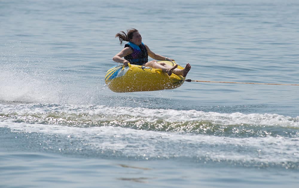 a girl cools off as she rides on a water donut at the Baltic Sea in Altefaehr, Germany. From Spain to Poland, temperatures have climbed as a mass of hot air from Africa has pushed northward.