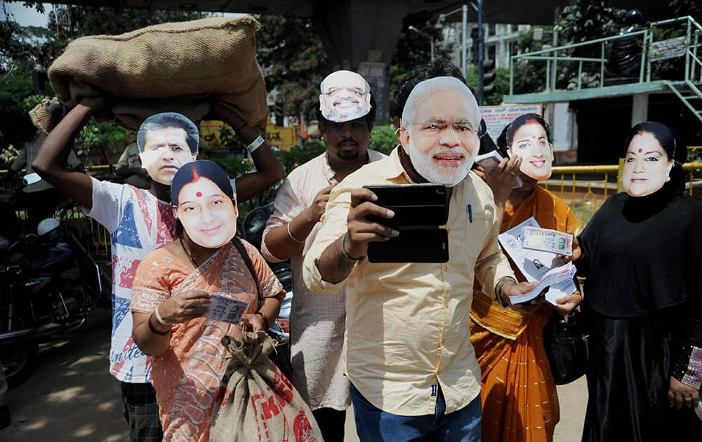 Members of NSUI wear masks of BJP leaders during a protest against BJP President Amit Shah regarding inaction against his corrupted party leaders despite several allegations against them in Bengaluru.