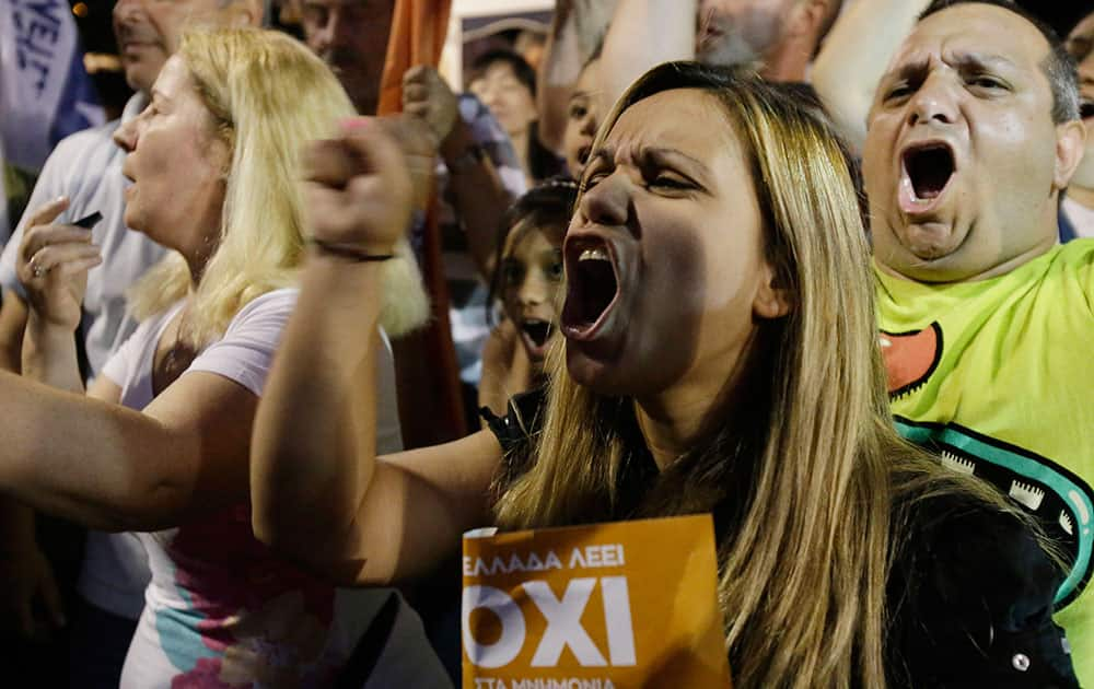 Supporters of the No vote react after the first results of the referendum at Syntagma square in Athens.