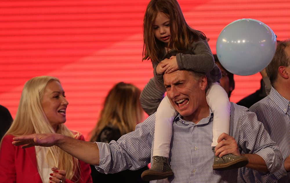 Carrying his daughter Antonia and surrounded by supporters, the current Mayor of Buenos Aires and presidential candidate Mauricio Macri celebrates at the end of mayoral elections in Buenos Aires, Argentina.