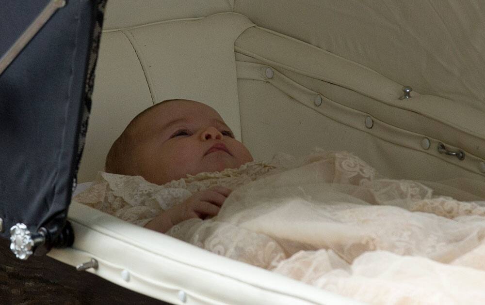 Britain's Princess Charlotte is pushed in a pram by her mother Kate the Duchess of Cambridge as they arrive for Charlotte's Christening at St. Mary Magdalene Church in Sandringham, England.