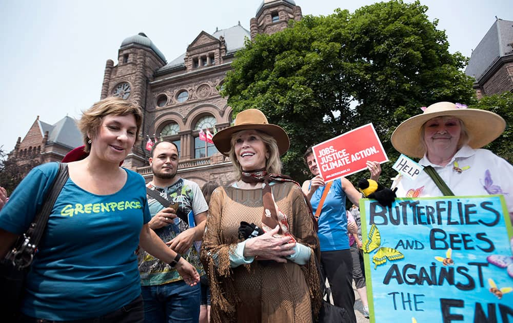 Actress and activist Jane Fonda, center, joins a rally before the Climate Summit of the Americas and the Pan American Economic Summit, in Toronto. 