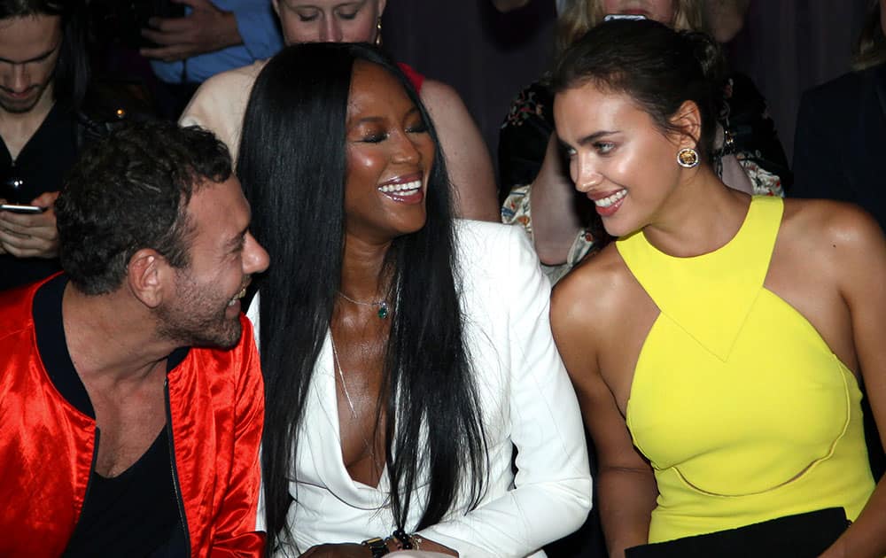 British born model Naomi Campbell, center, and Russian model Irina Shayk, right, attend Versace's fall-winter 2015/2016 Haute Couture fashion collection presented in Paris France.