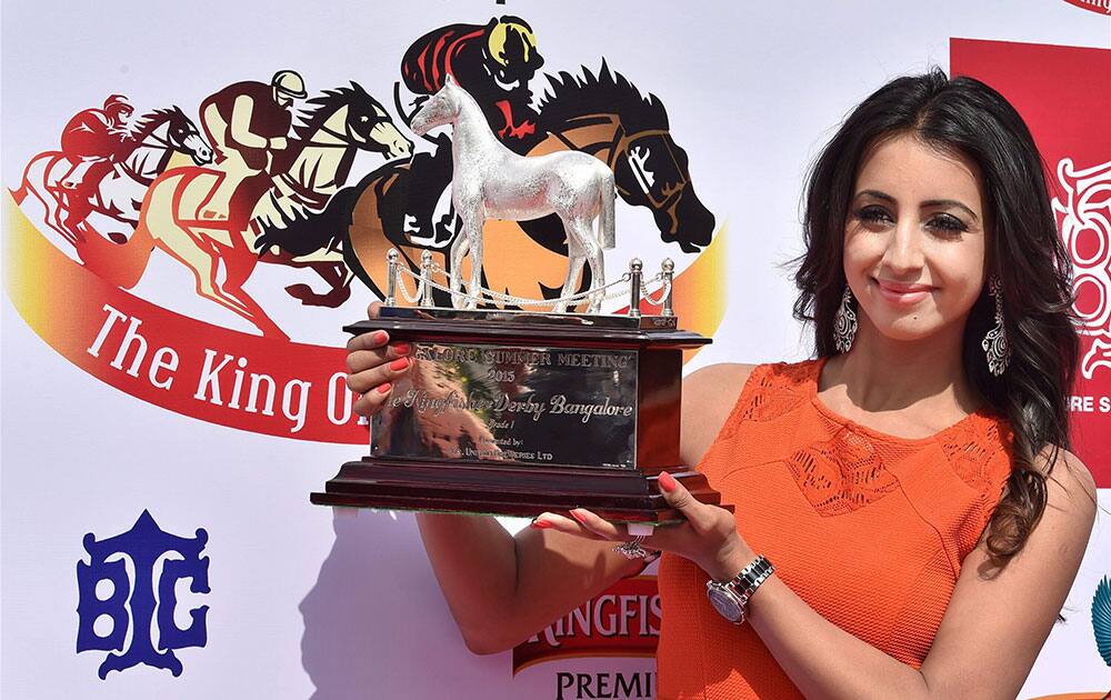 Kannada Actress Sanjana with the Kingfisher Derby trophy during its unveiling at Bangalore Turf Club.