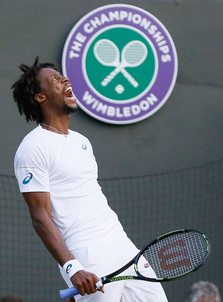 Gael Monfis of France shouts out after missing a shot during the singles match against Gilles Simon of France at the All England Lawn Tennis Championships in Wimbledon, London.