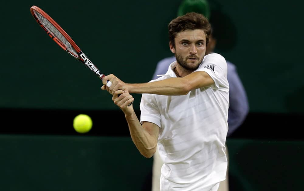 Gilles Simon of France returns to Gael Monfils of France during their singles match at the All England Lawn Tennis Championships in Wimbledon, London.