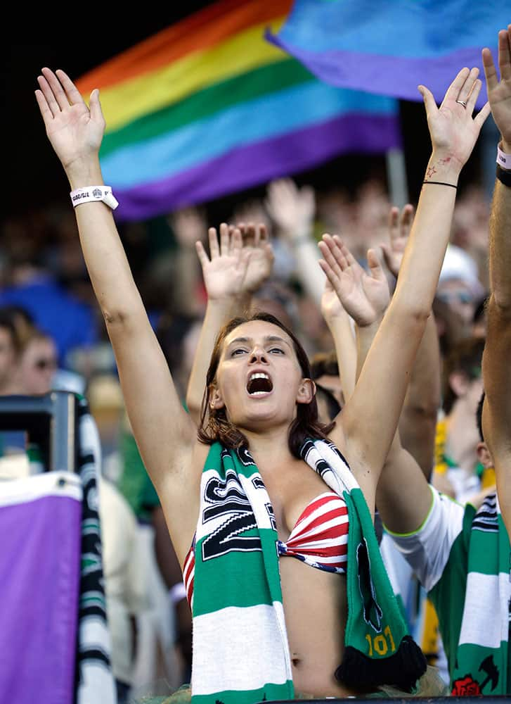 A Portland Timbers fans cheers as the team takes the field before an MLS soccer game against the San Jose Earthquakes in Portland, Ore.