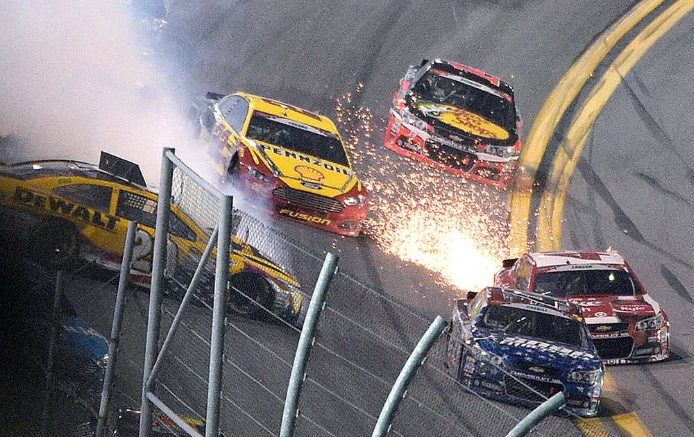 att Kenseth (20) spins in Turn 4 as Joey Logano (22), Tony Stewart (14), Kyle Larson (42) and Landon Cassill try to avoid him during a NASCAR Sprint Cup series auto race at Daytona International Speedway in Daytona Beach, Fla.