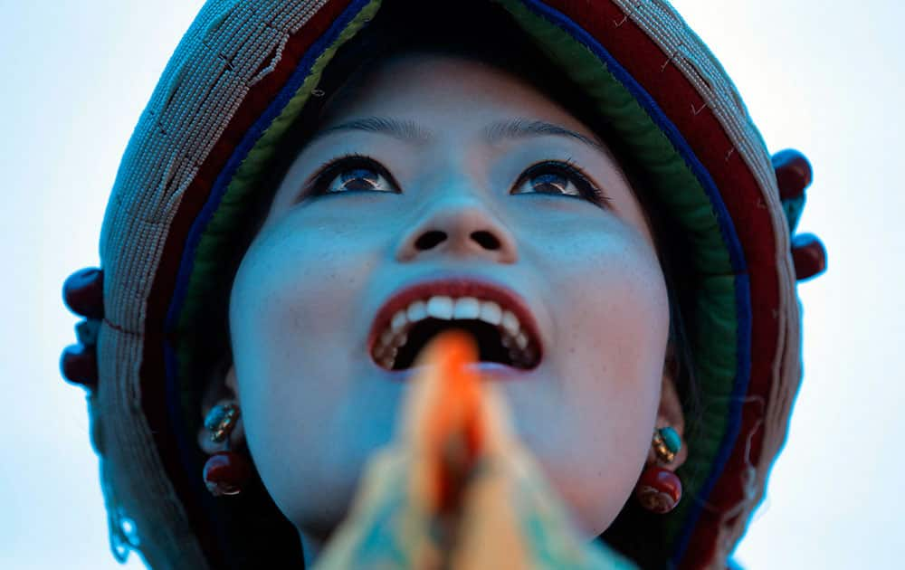 A woman sings as Tibetans celebrate the 80th birthday of their spiritual leader, the Dalai Lama, in Kathmandu, Nepal.