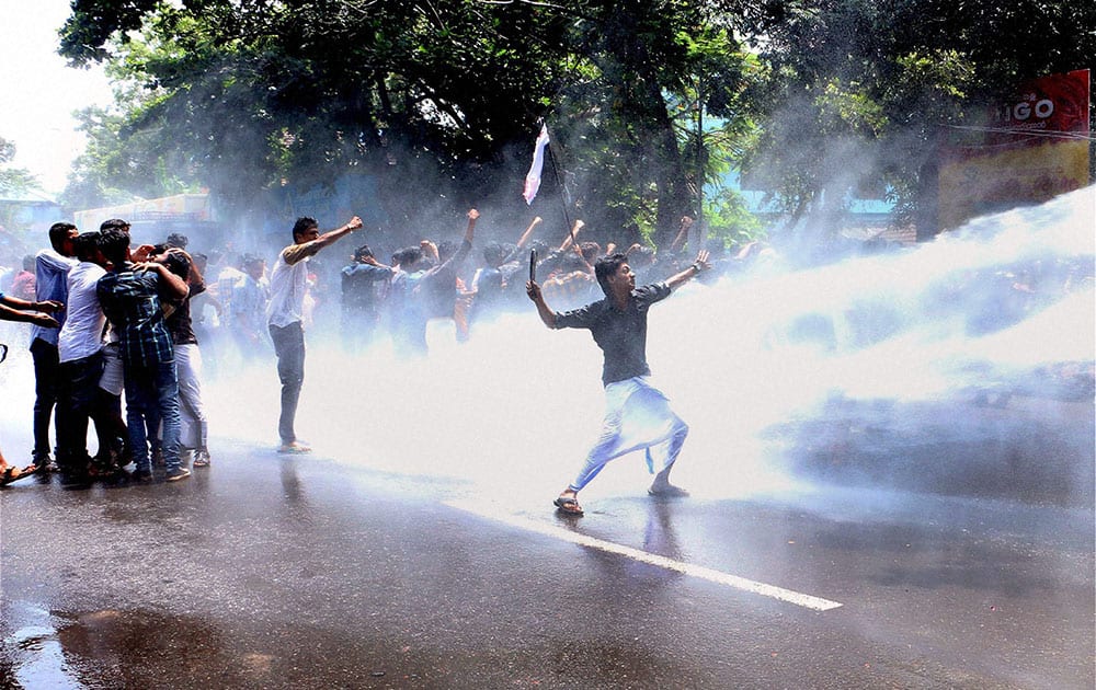 Police use water cannon against DYFI workers during a protest demanding Text Book availability for students in Kozhikode.