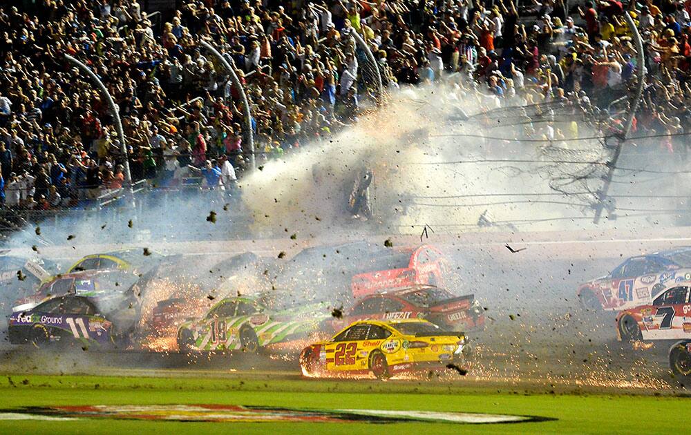 Austin Dillon (3) goes airborne and hits the catch fence as he was involved in a multi-car crash on the final lap of the NASCAR Sprint Cup series auto race at Daytona International Speedway in Daytona Beach, Fla.