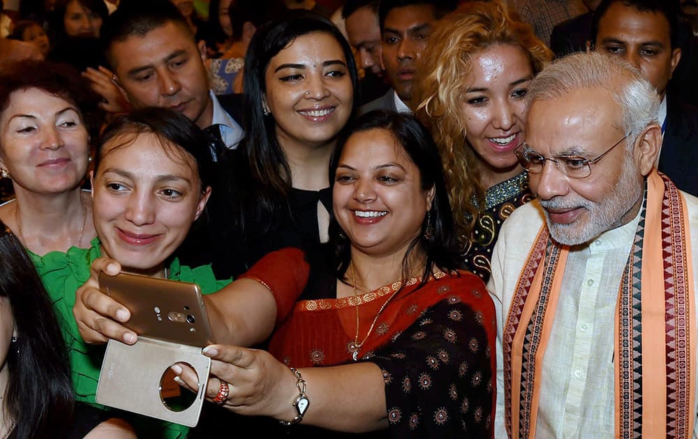 A woman takes selfie with Prime Minister Narendra Modi during his interaction with Indologists, students of Hindi and Indian community members, in Tashkent, Uzbekistan.