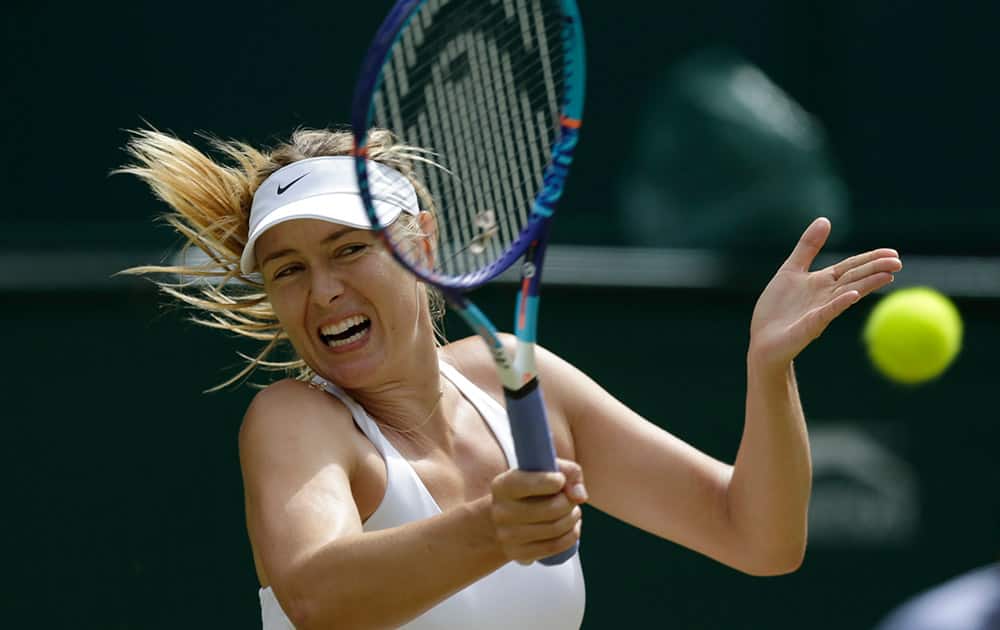 Maria Sharapova of Russia returns a ball to Coco Vandeweghe of the United States during their singles match at the All England Lawn Tennis Championships in Wimbledon, London.