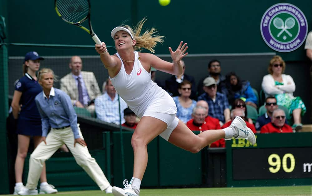 Coco Vandeweghe of the United States returns a ball to Maria Sharapova of Russia, during their singles match at the All England Lawn Tennis Championships in Wimbledon, London.