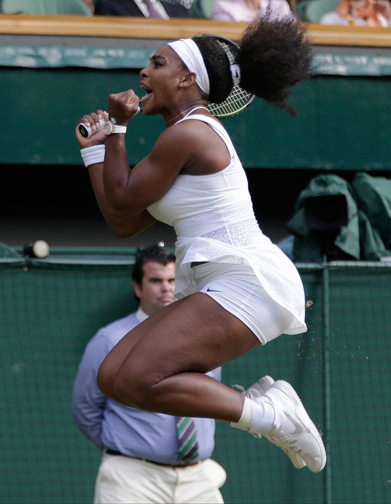 Serena Williams of the United States jumps as she celebrates winning the singles match against Victoria Azarenka of Belarus, at the All England Lawn Tennis Championships in Wimbledon, London.