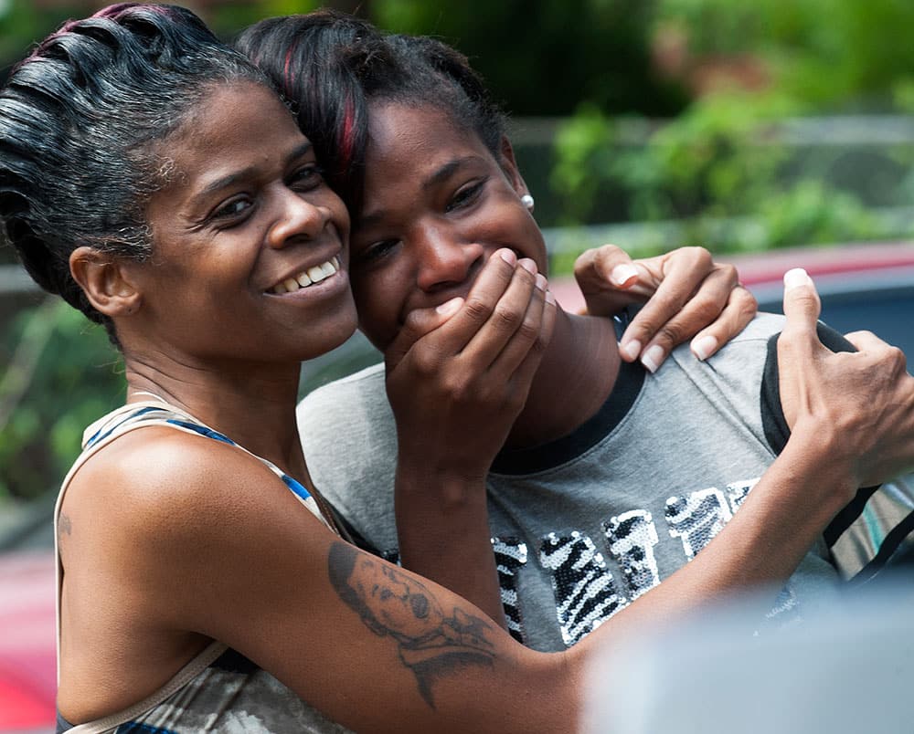 Jessica Byrd, right, reacts with her mother Hattie Byrd after seeing a rendering of the home being built for her during a groundbreaking ceremony in Montgomery, Ala. 